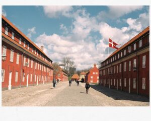a group of people walking on a cobblestone road