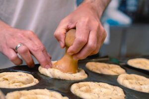 a person making pastries in a pan
