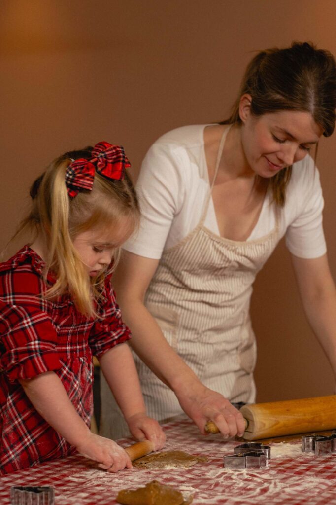a woman and a child making cookies