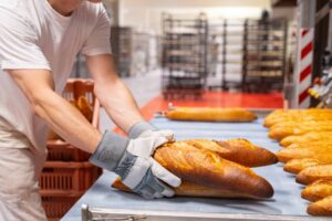 a person holding a loaf of bread