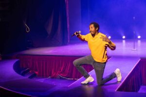 a man on stage with microphone