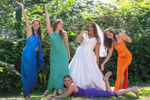 a group of women in dresses posing for a picture