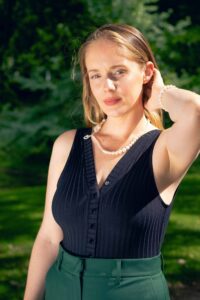 a woman with her hand behind her ear