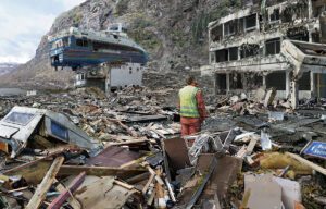 a man looking at a building that has a ship flying over it